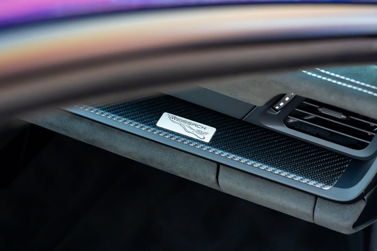 2025 Porsche 911 GT3 RS Weissach Package interior badge with carbon fiber trim.