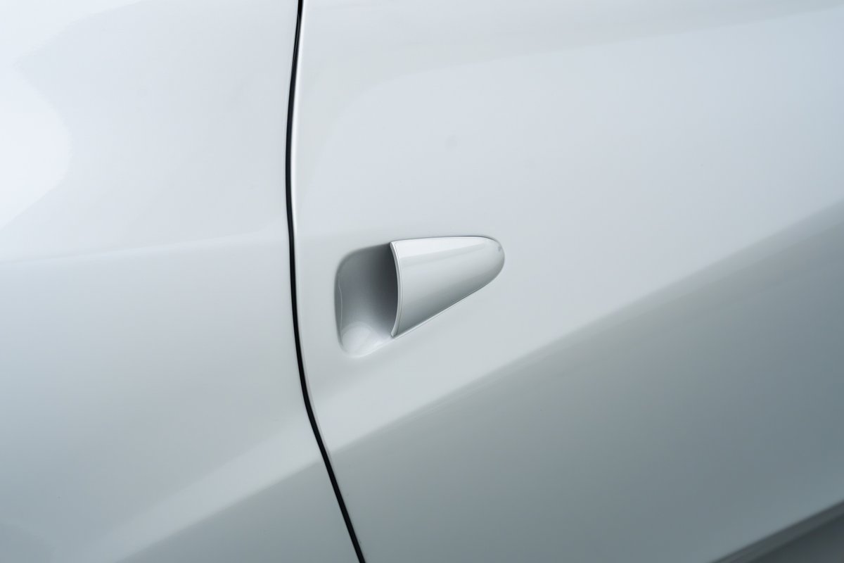 Close-up of the flush door handle on a white 2015 Ferrari 458 Speciale.