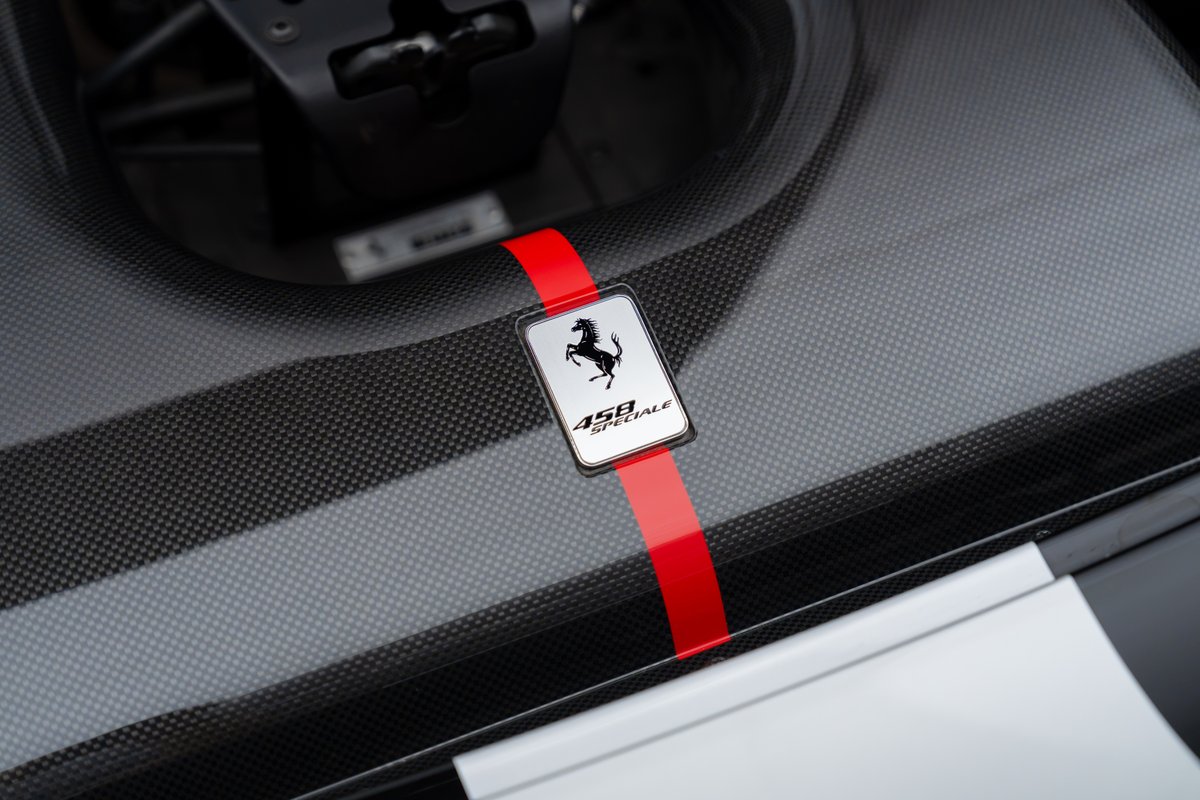 Ferrari 458 Speciale badge with red stripe over carbon fiber engine cover.