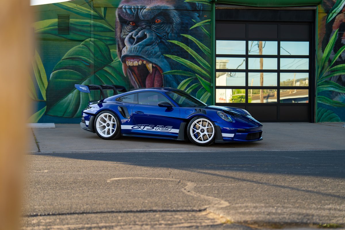 Blue 2025 Porsche 911 GT3 RS with white rims and GT3RS side livery.