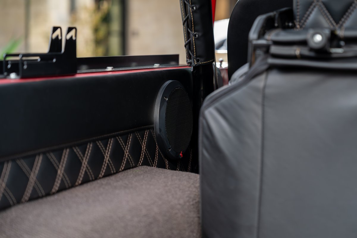 1966 Ford Bronco custom interior with a JL Audio speaker and diamond-stitched trim.
