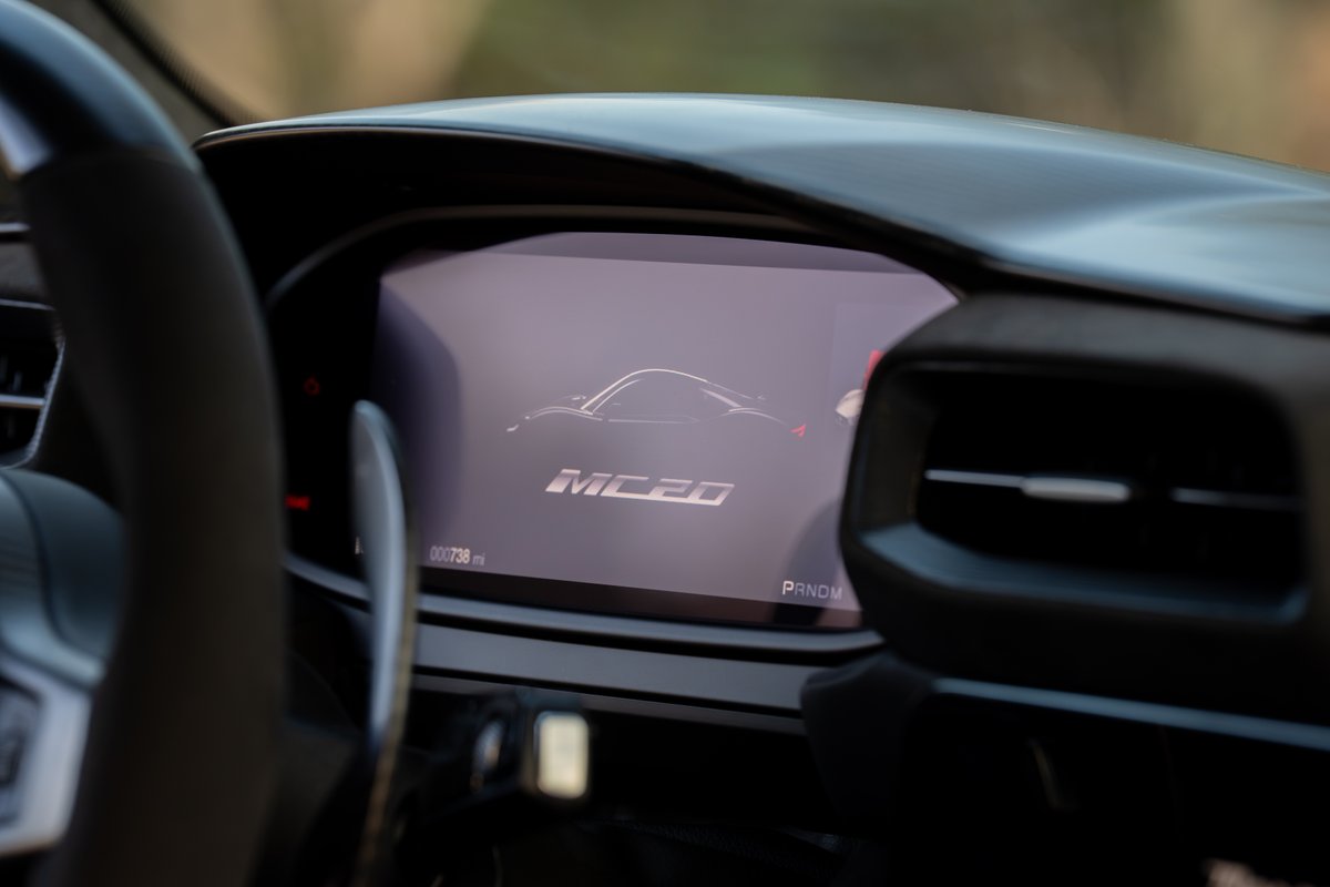 Maserati MC20 Icona digital dash displays model silhouette and "MC20" script.