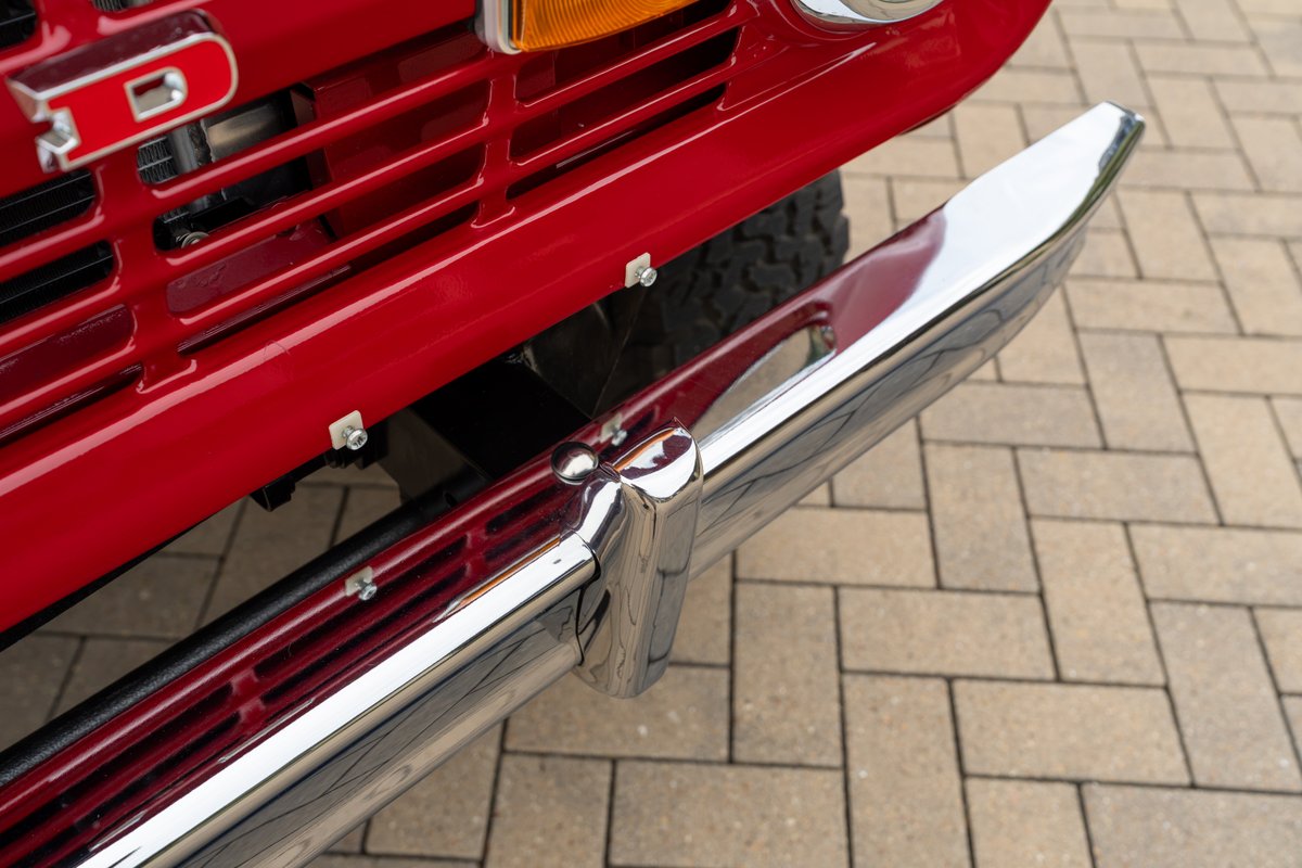 1966 Ford Bronco by Atlas Broncos, close-up of red grille and chrome bumper.