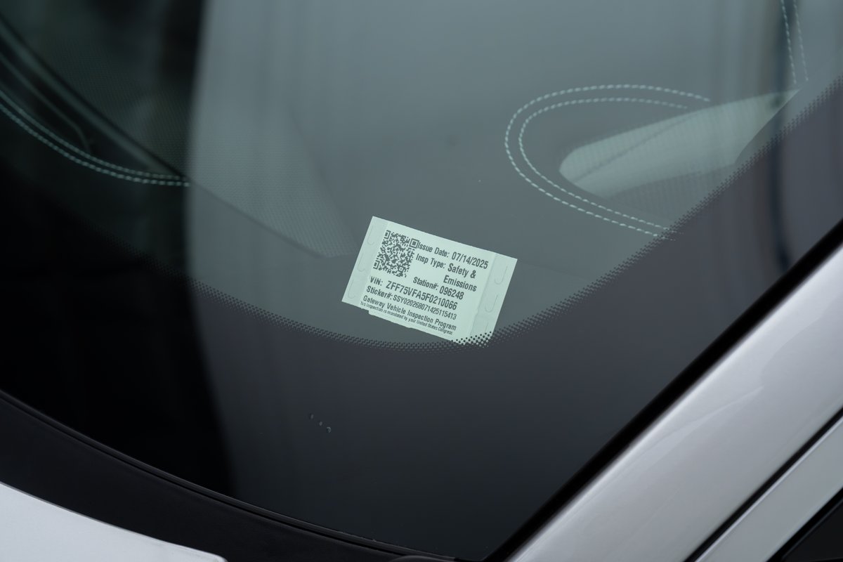 2015 Ferrari 458 Speciale windshield sticker displays safety and emissions inspection info.