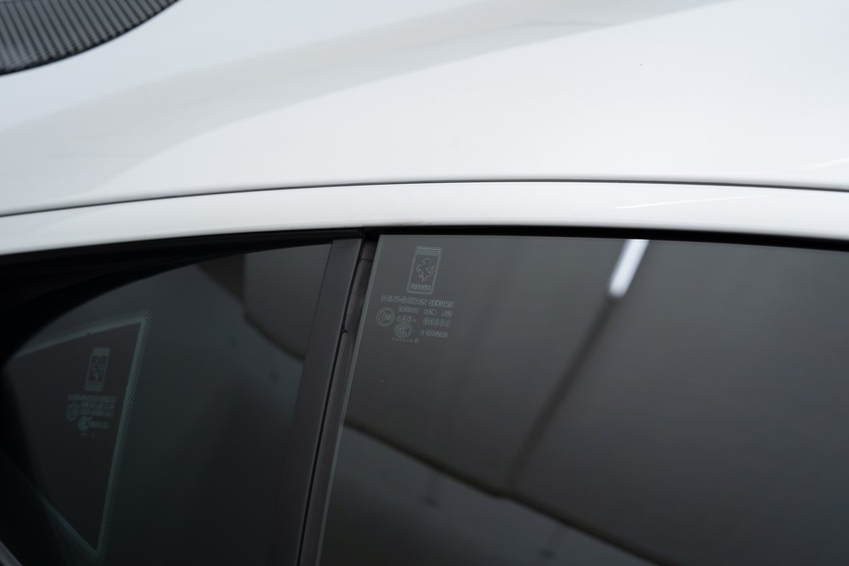 White 2015 Ferrari 458 Speciale side window with manufacturer markings.