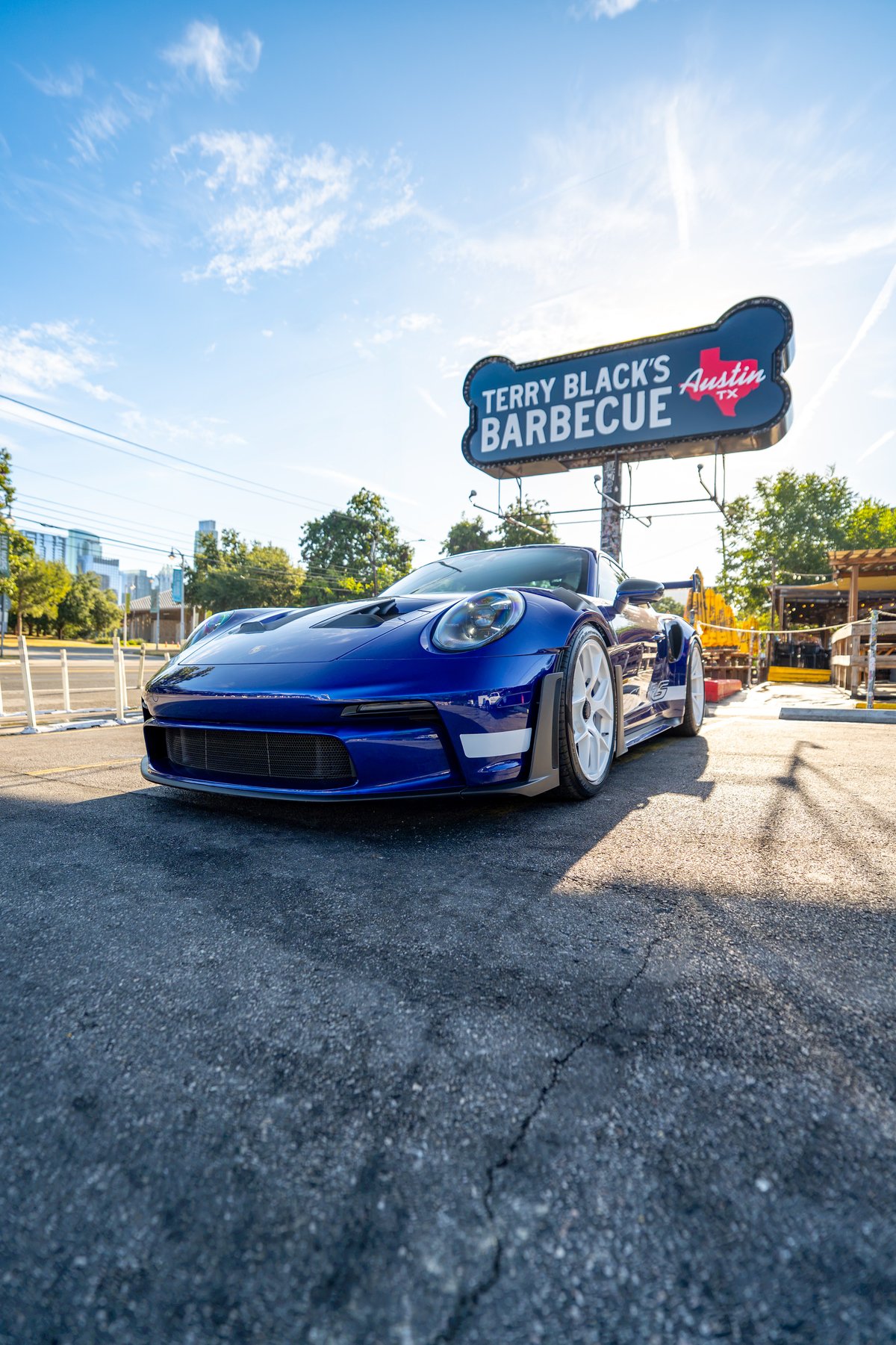 Blue 2025 Porsche 911 GT3 RS with white rims and performance trim.