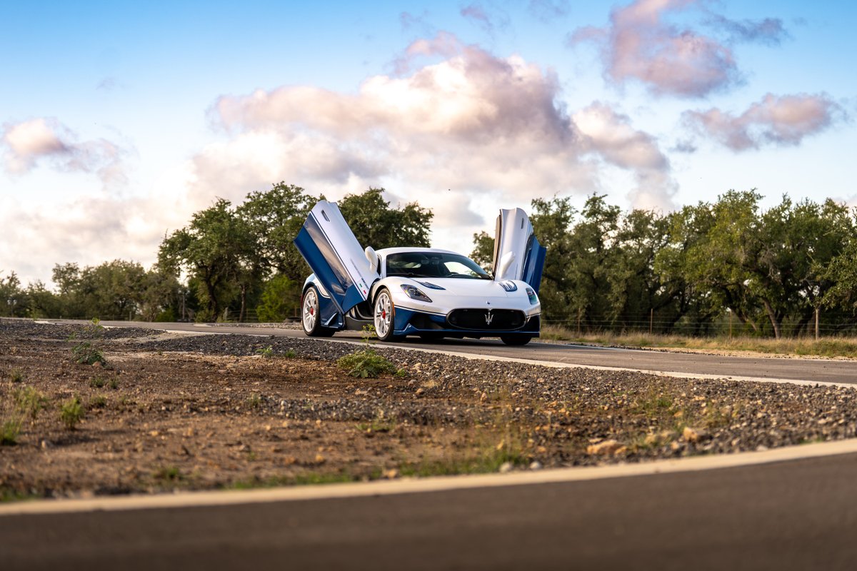 2024 Maserati MC20 Icona in white with blue livery and butterfly doors open.