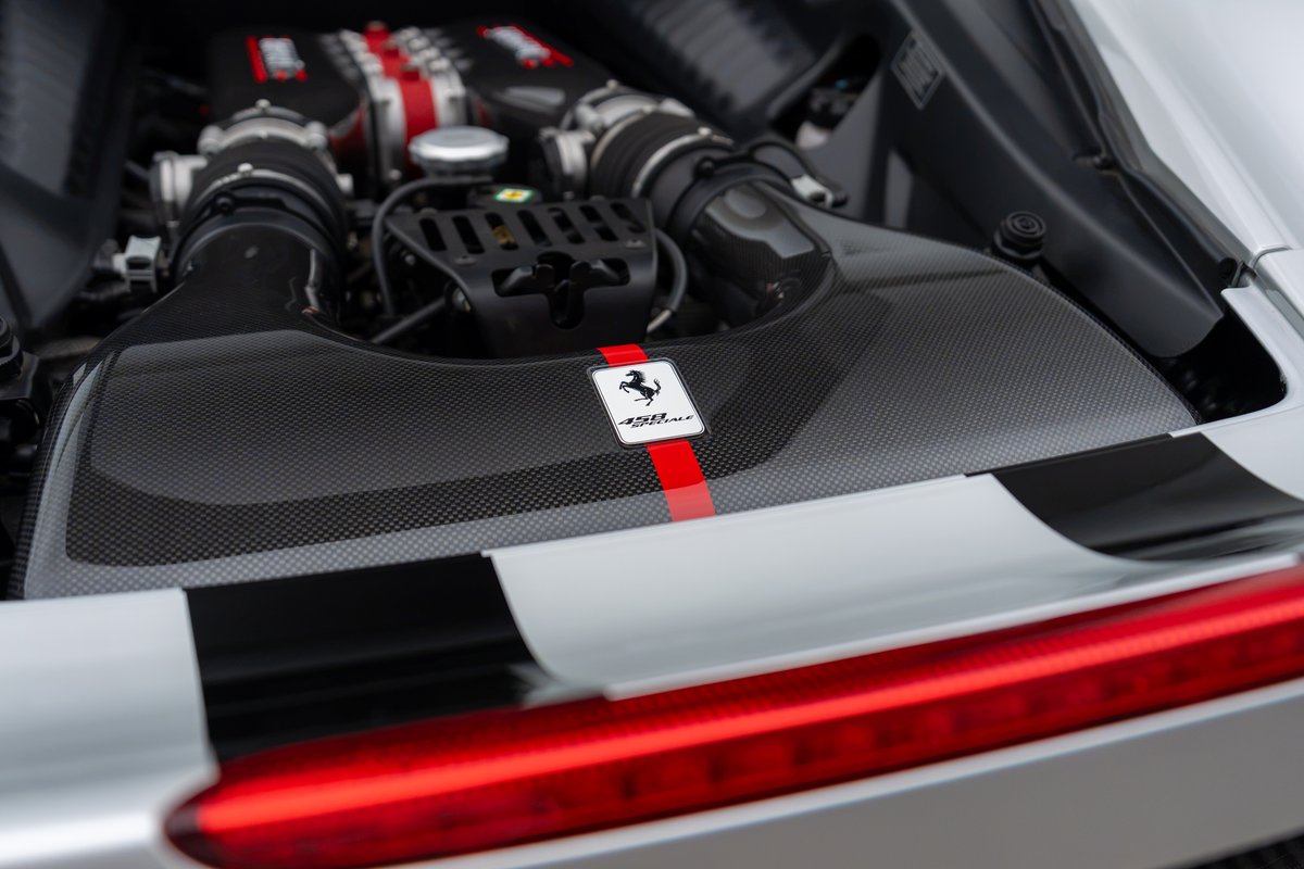 2015 Ferrari 458 Speciale engine bay with carbon fiber trim and racing stripes.