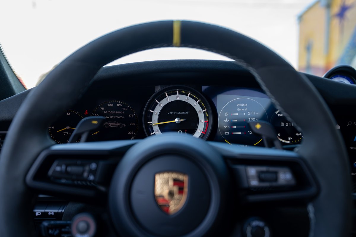 2025 Porsche 911 GT3 RS dashboard with GT3 RS script, digital display, and yellow 12 o'clock marker.