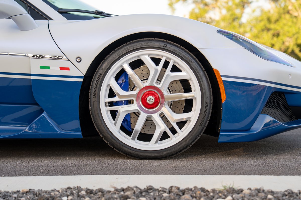 Maserati MC20 Icona with white and blue livery, Bridgestone tires, and silver rims.