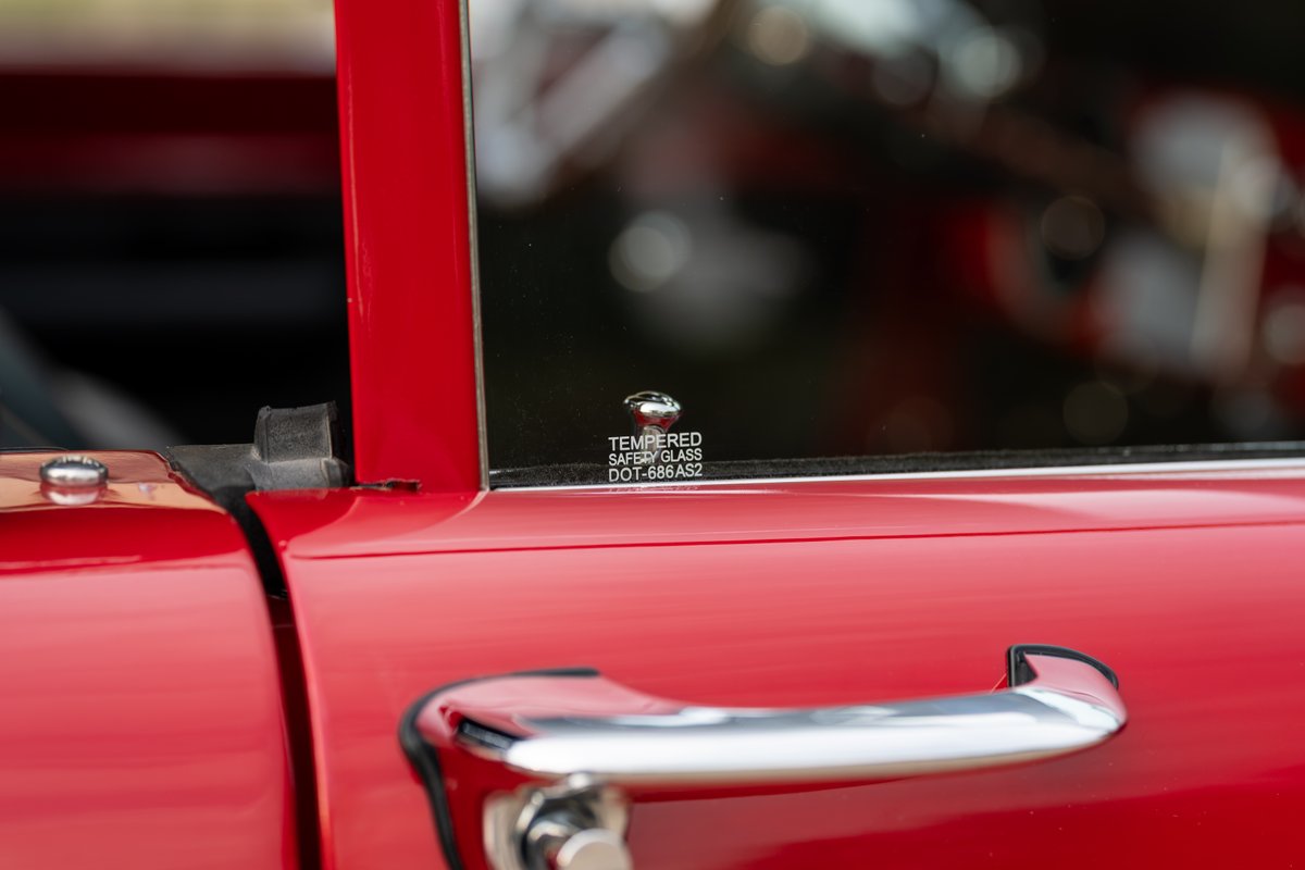 1966 Ford Bronco side door with chrome handle and tempered glass.