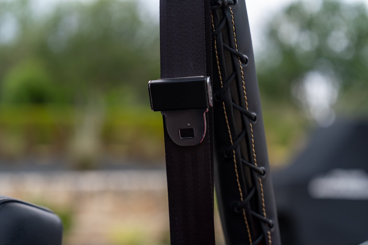 1966 Ford Bronco, black seatbelt with black trim and tan stitching.