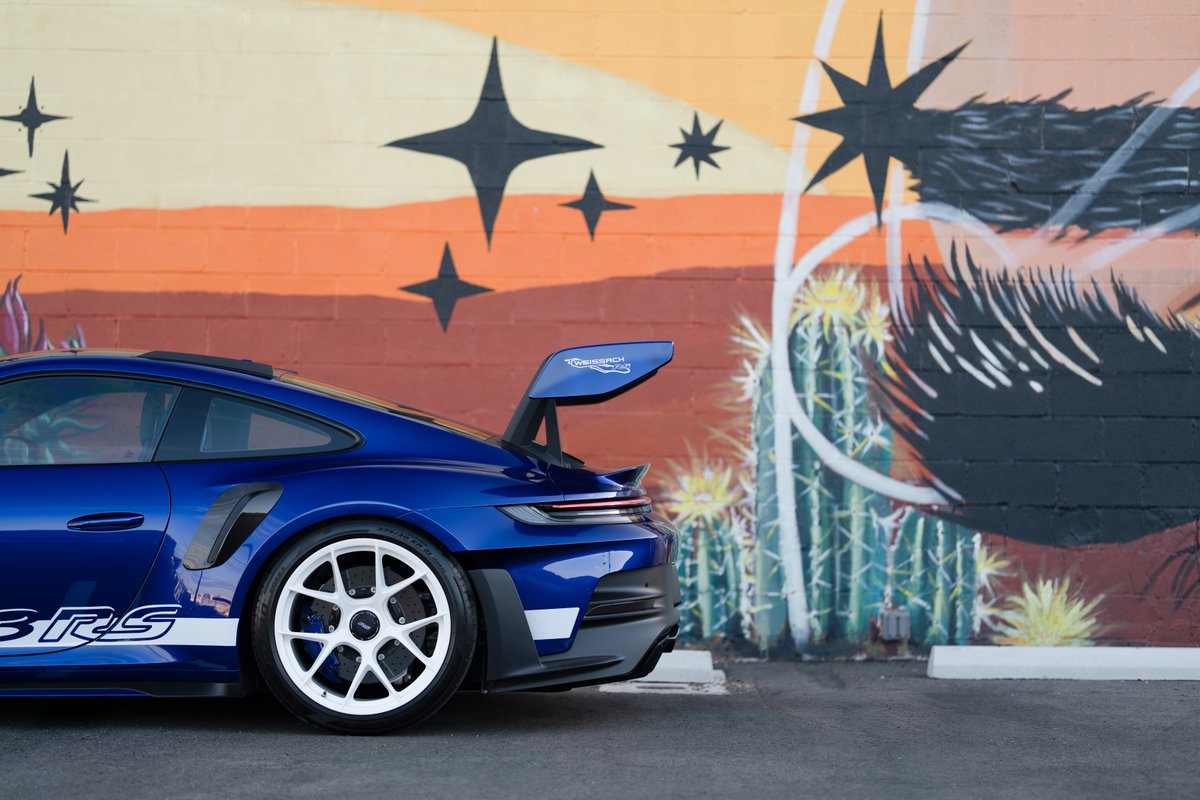 2025 Porsche 911 GT3 RS in blue, featuring white racing livery and white center-lock rims.