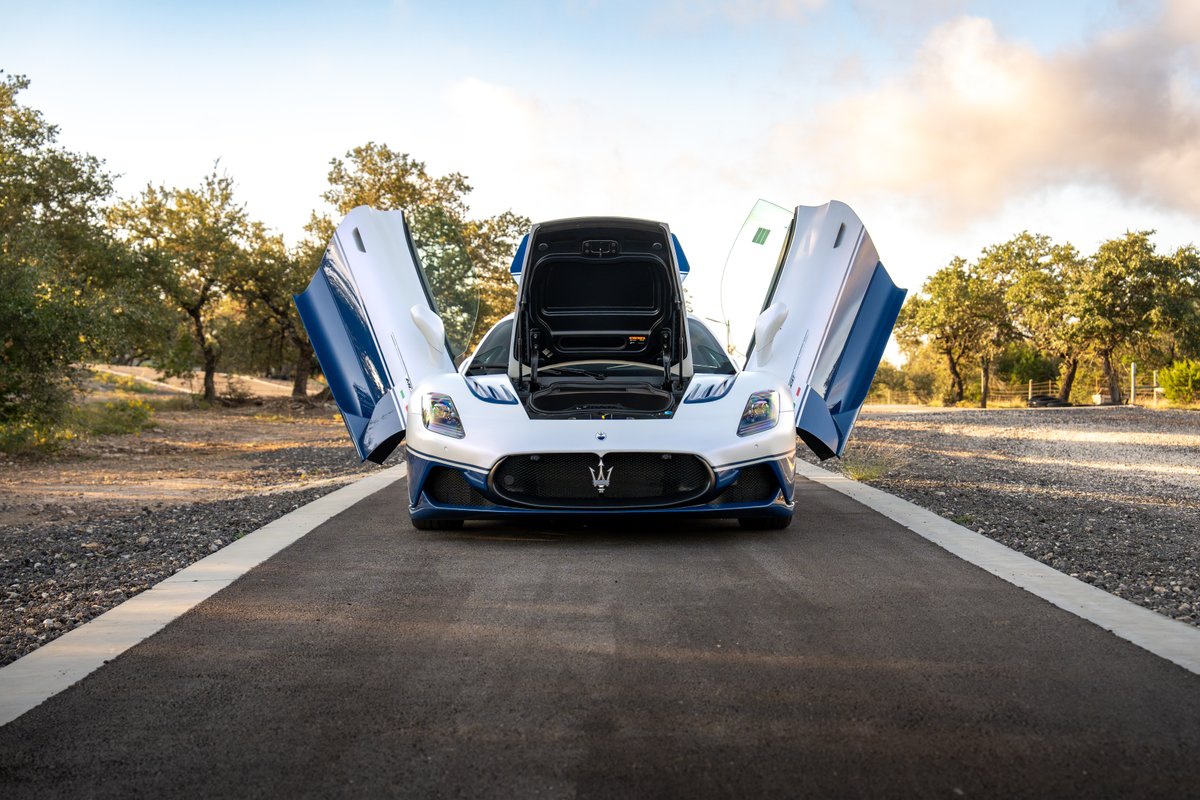 2024 Maserati MC20 Icona in white with blue trim and accents, dihedral doors open.