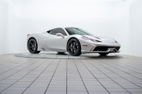 A silver 2015 Ferrari 458 Speciale with black rims is shown on a rotating display.