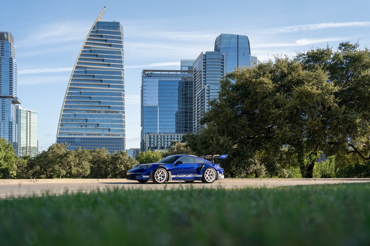2025 Porsche 911 GT3 RS in blue with white livery and racing rims.