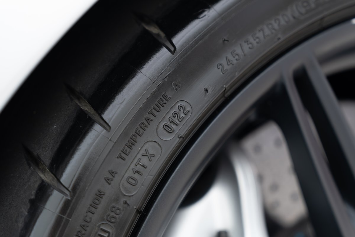 Close-up of a 2015 Ferrari 458 Speciale tire with 245/35ZR20 specs on a dark rim.