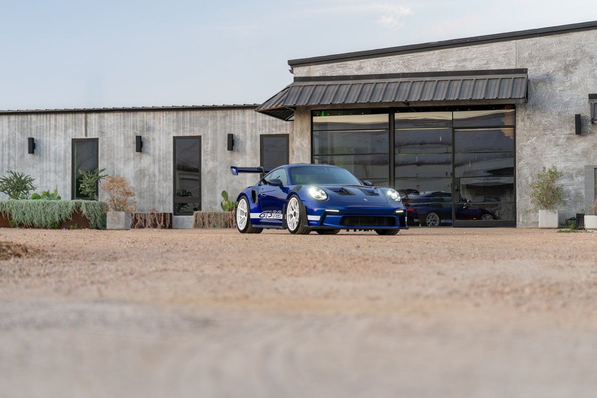 Blue 2025 Porsche 911 GT3 RS with white center-lock rims and GT3 RS livery.