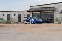 Blue 2025 Porsche 911 GT3 RS with white center-lock rims and GT3 RS livery.