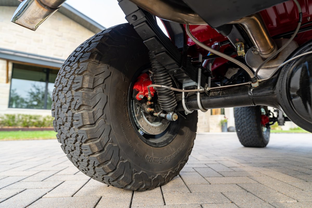 Close-up of a red 1966 Ford Bronco rear tire with BFGoodrich all-terrain tread.