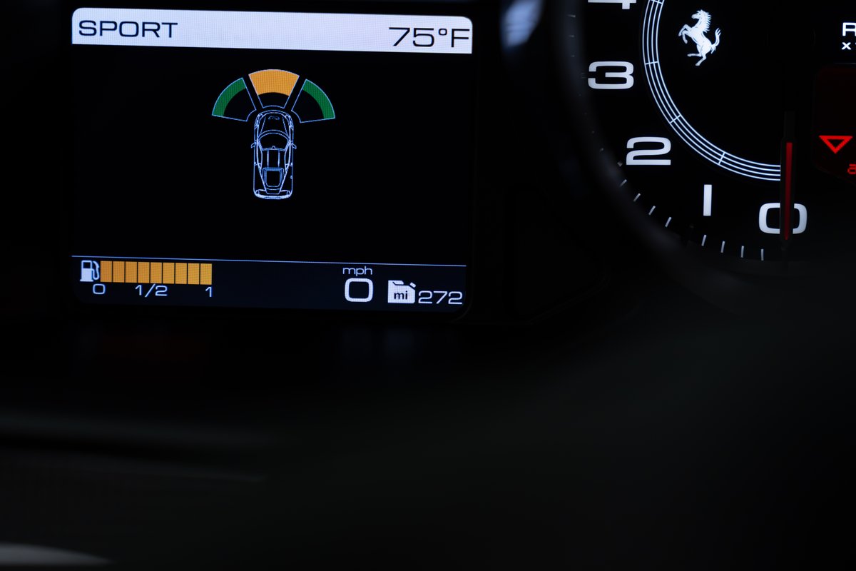2015 Ferrari 458 Speciale digital dash: "SPORT" mode, 75°F, park assist, 1/2 tank fuel, 0 mph, 272 miles.