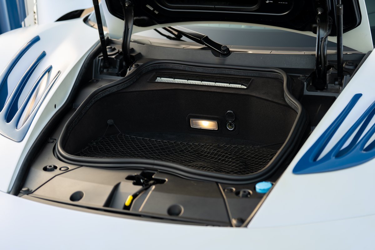 2024 Maserati MC20 Icona front trunk with blue racing livery trim and white paint.