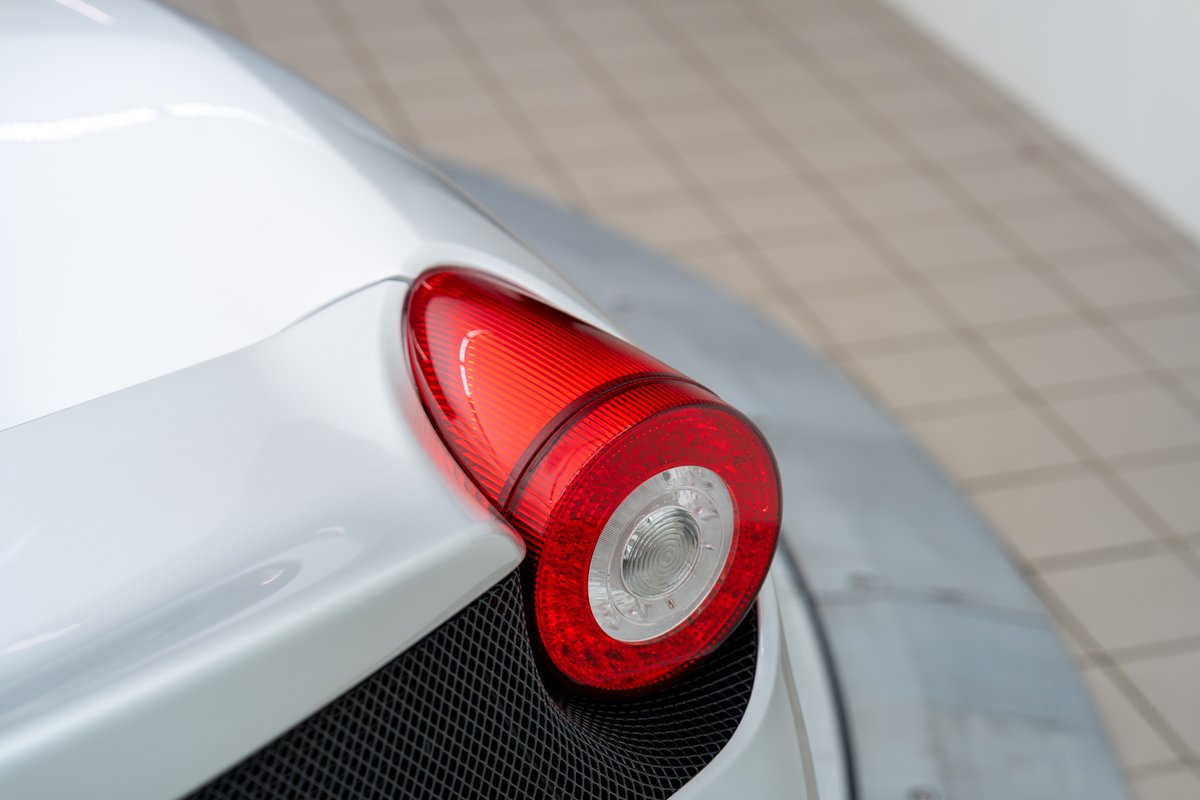 Close up of a white 2015 Ferrari 458 Speciale's rear LED taillight.