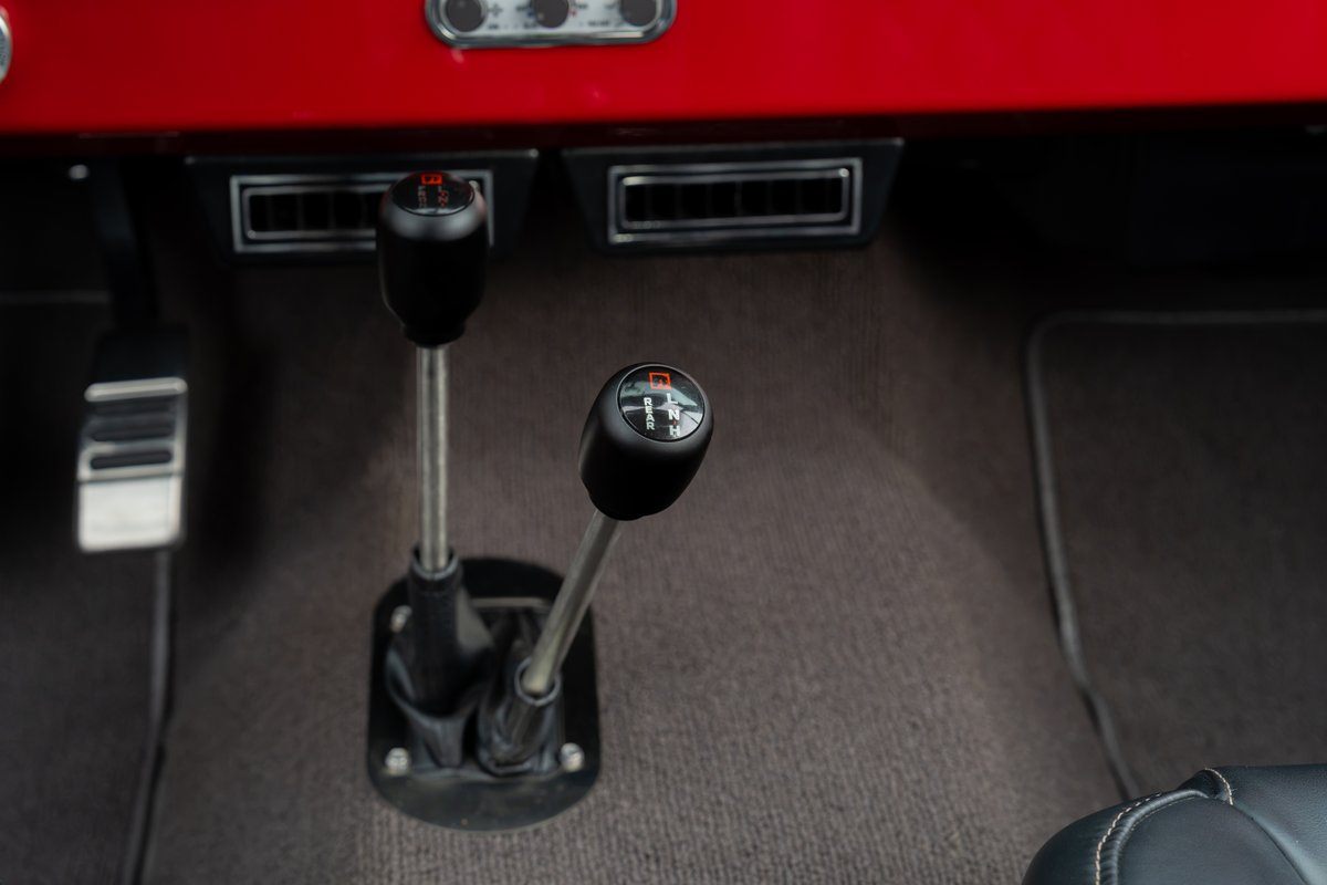 1966 Ford Bronco with manual transmission and transfer case gear selectors.