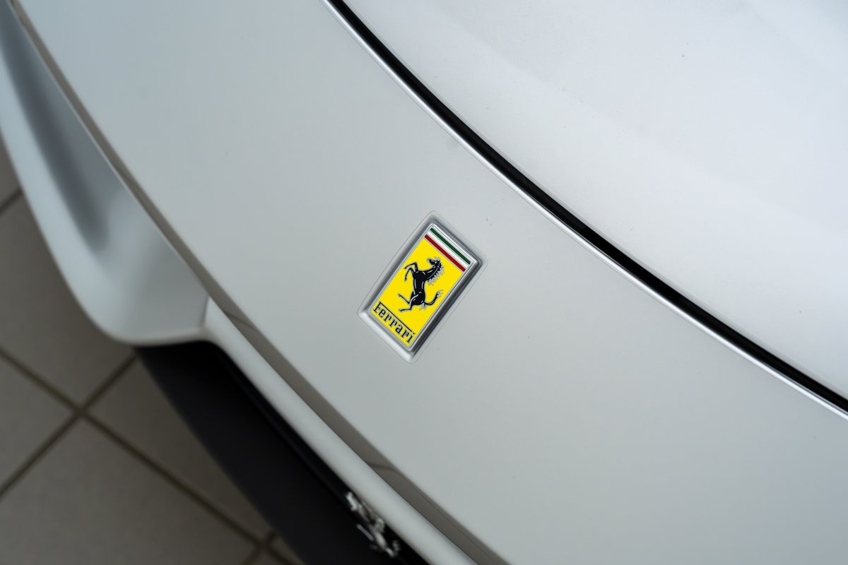 White 2015 Ferrari 458 Speciale with the iconic Cavallino Rampante emblem.