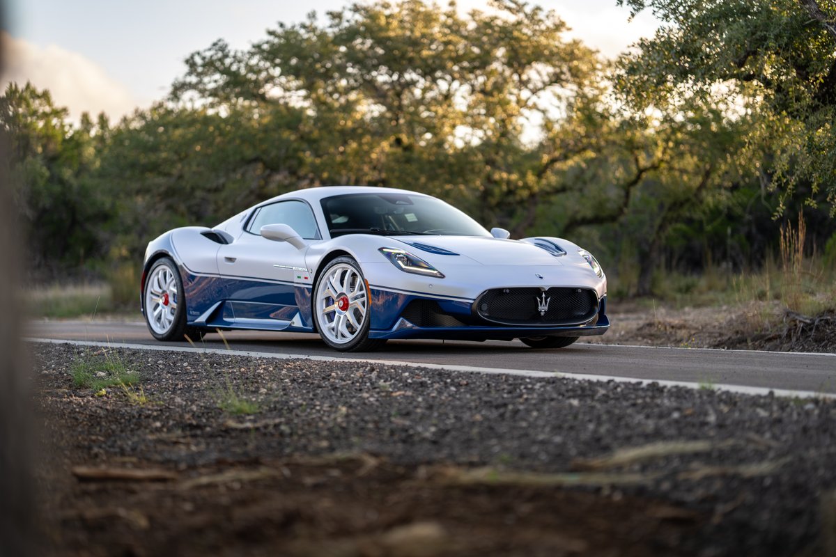 2024 Maserati MC20 Icona in white with blue livery, white rims, and trident grille.