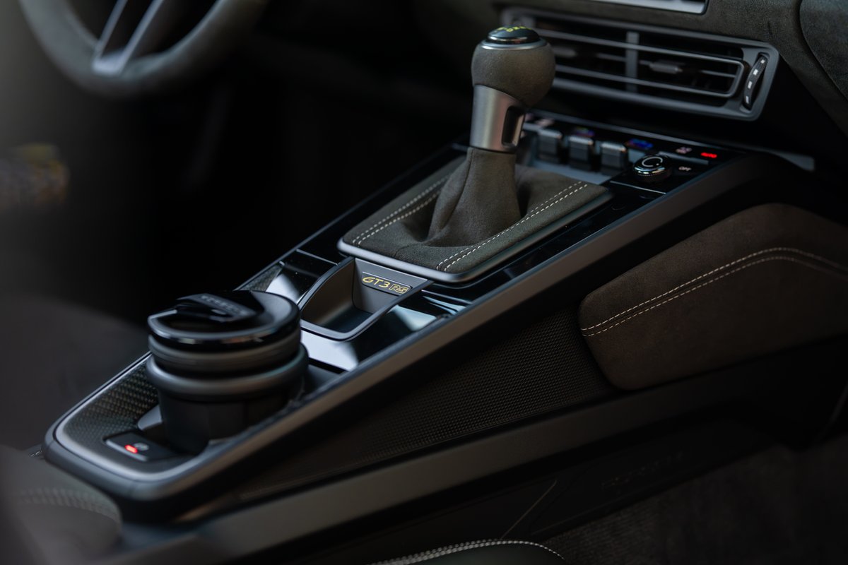 Close up of the 2025 Porsche 911 GT3 RS manual shifter and center console controls.