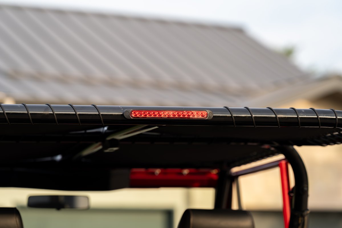 1966 Ford Bronco's black roof rack with integrated red LED third brake light.