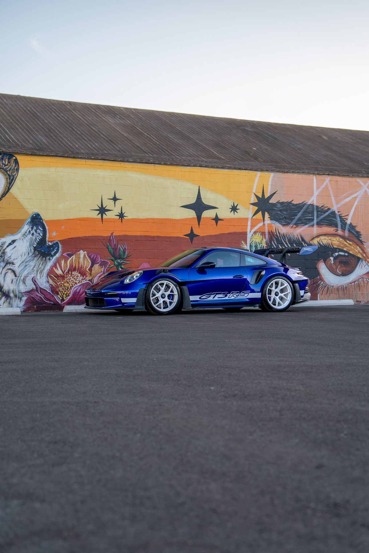 2025 Porsche 911 GT3 RS in Pythonic Blue with white GT3 RS livery and white rims.