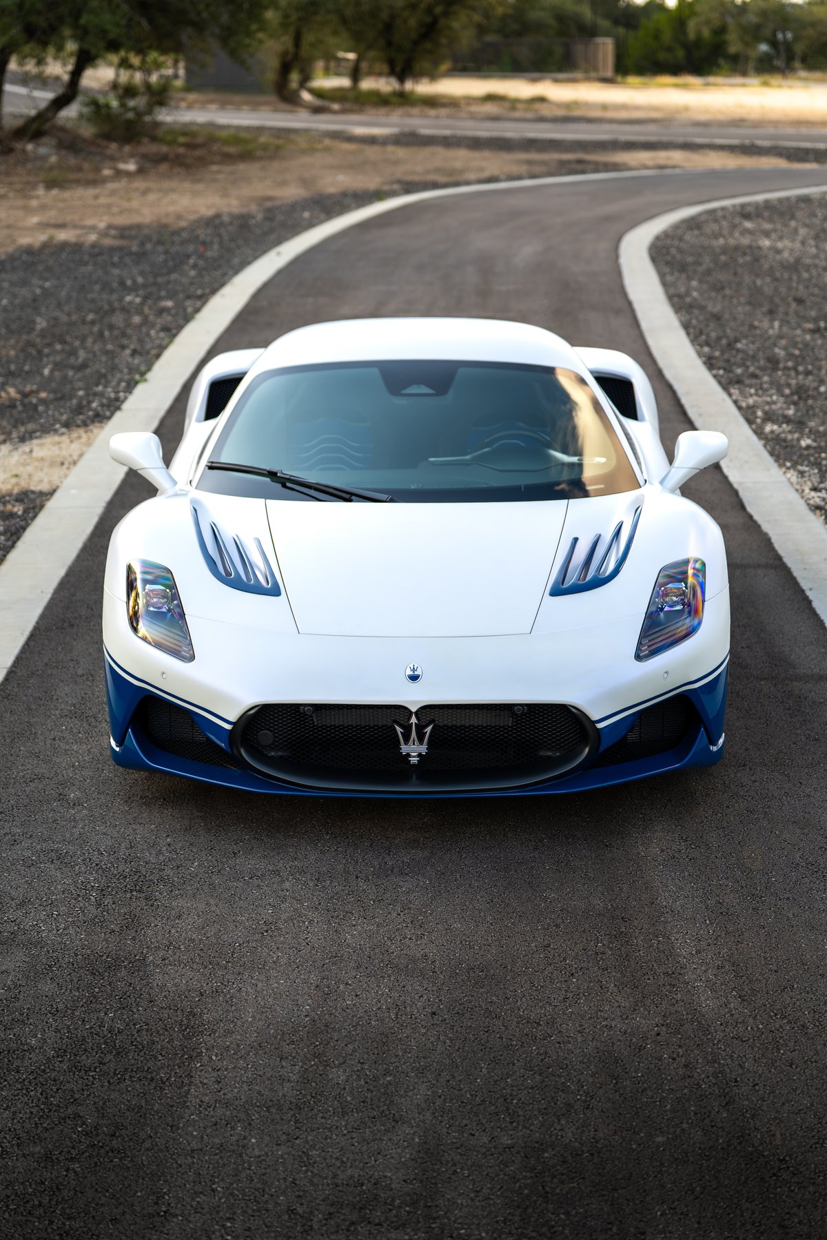 White 2024 Maserati MC20 Icona with blue trim and accents.