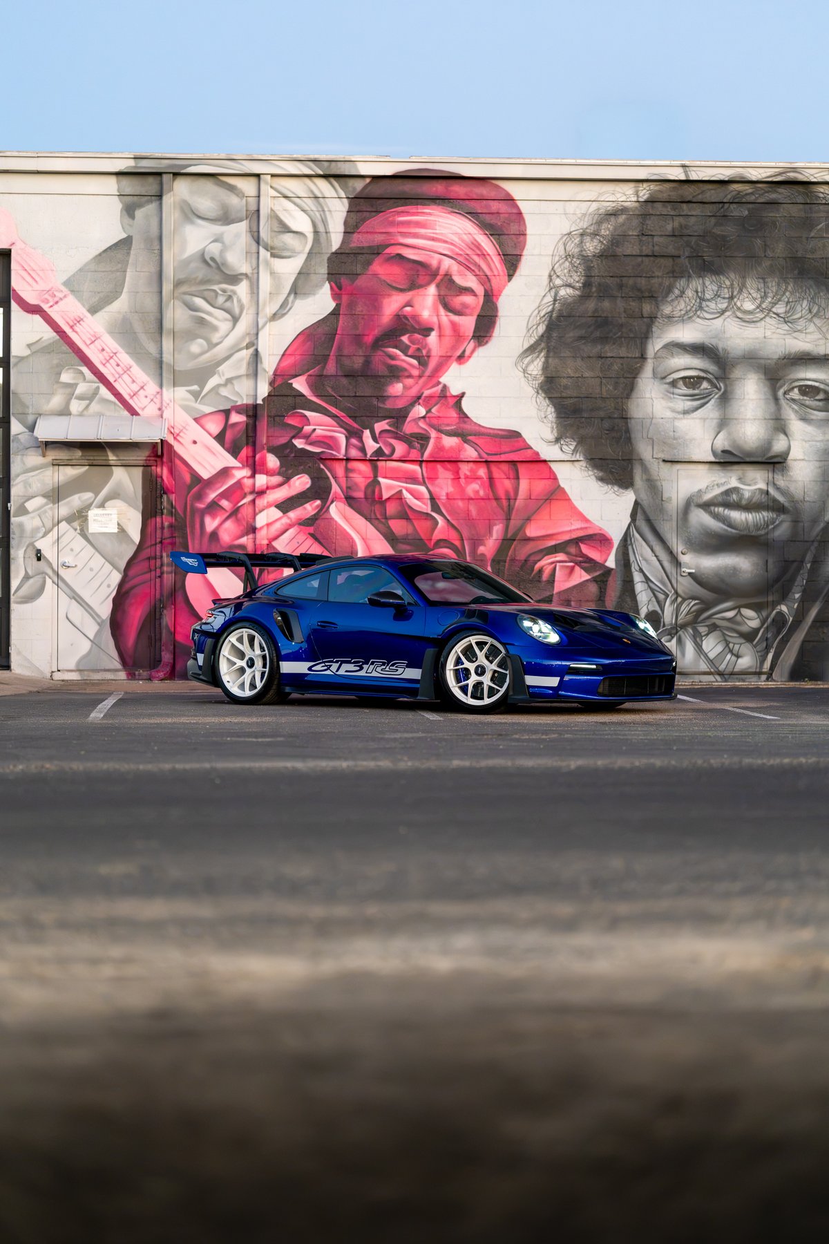 Blue 2025 Porsche 911 GT3 RS with white rims and GT3 RS livery.