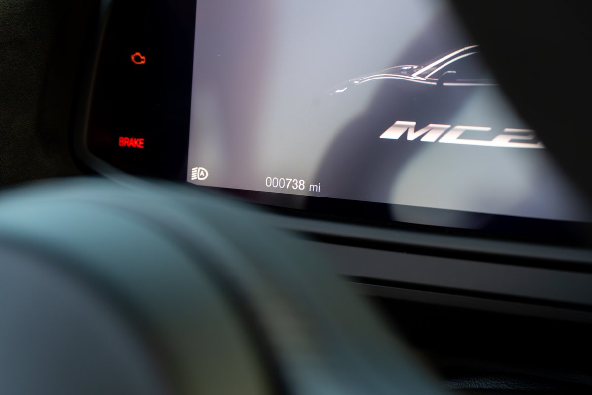 2024 Maserati MC20 Icona dashboard displays 738 miles, brake light illuminated.