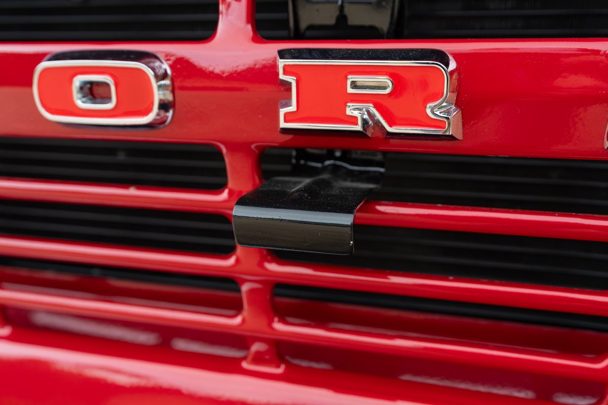 1966 Ford Bronco grille in red with chrome "O" and "R" badging.