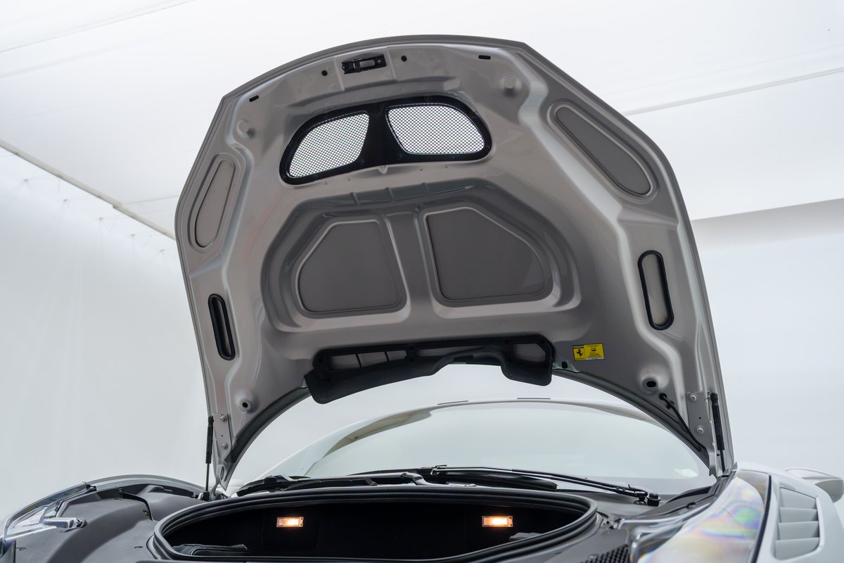 Silver 2015 Ferrari 458 Speciale hood interior with mesh vents.