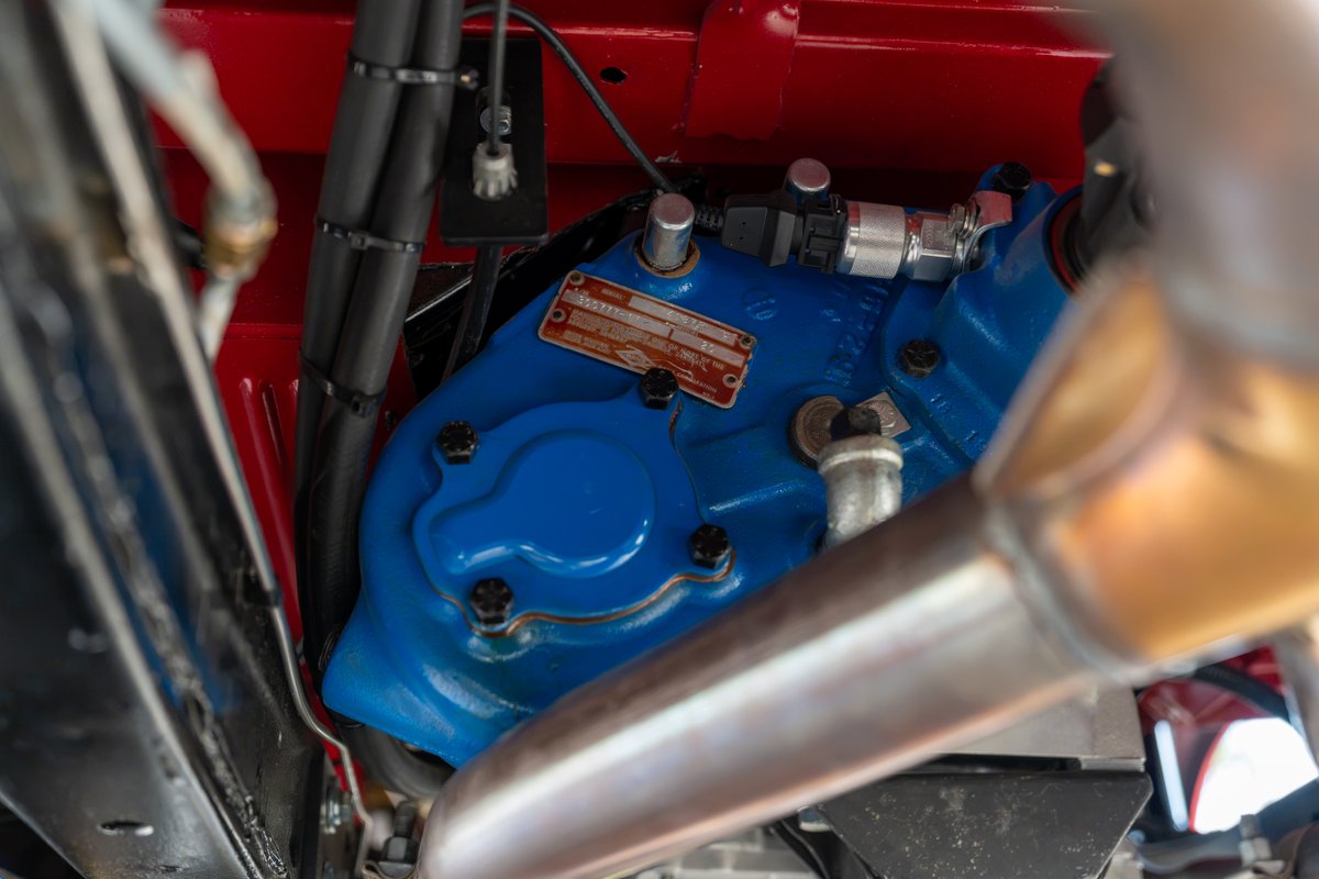 Custom blue transfer case on a 1966 Ford Bronco chassis with red body panels.