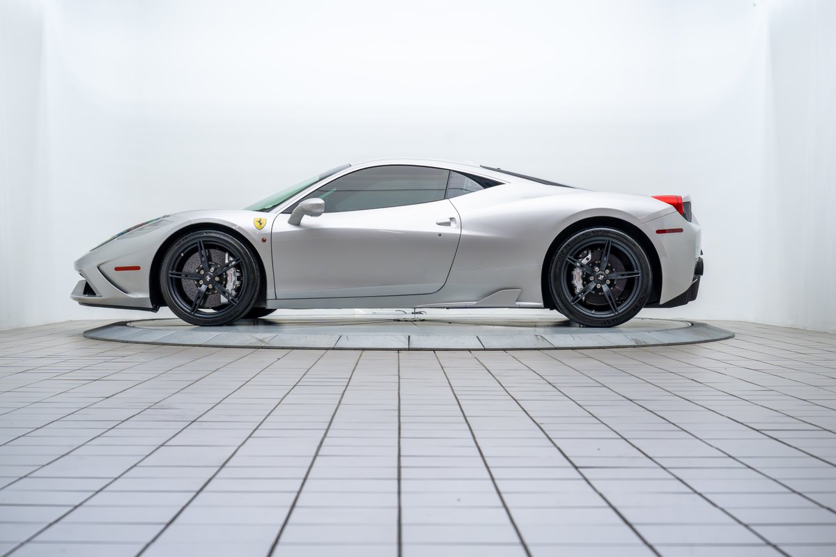 Silver 2015 Ferrari 458 Speciale with black rims and performance trim.