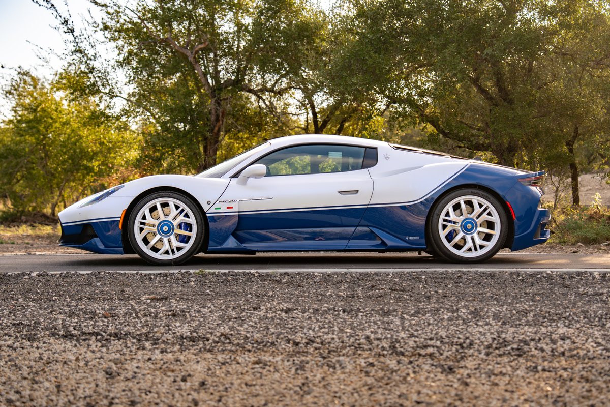 2024 Maserati MC20 Icona in white and blue livery with multi-spoke rims.