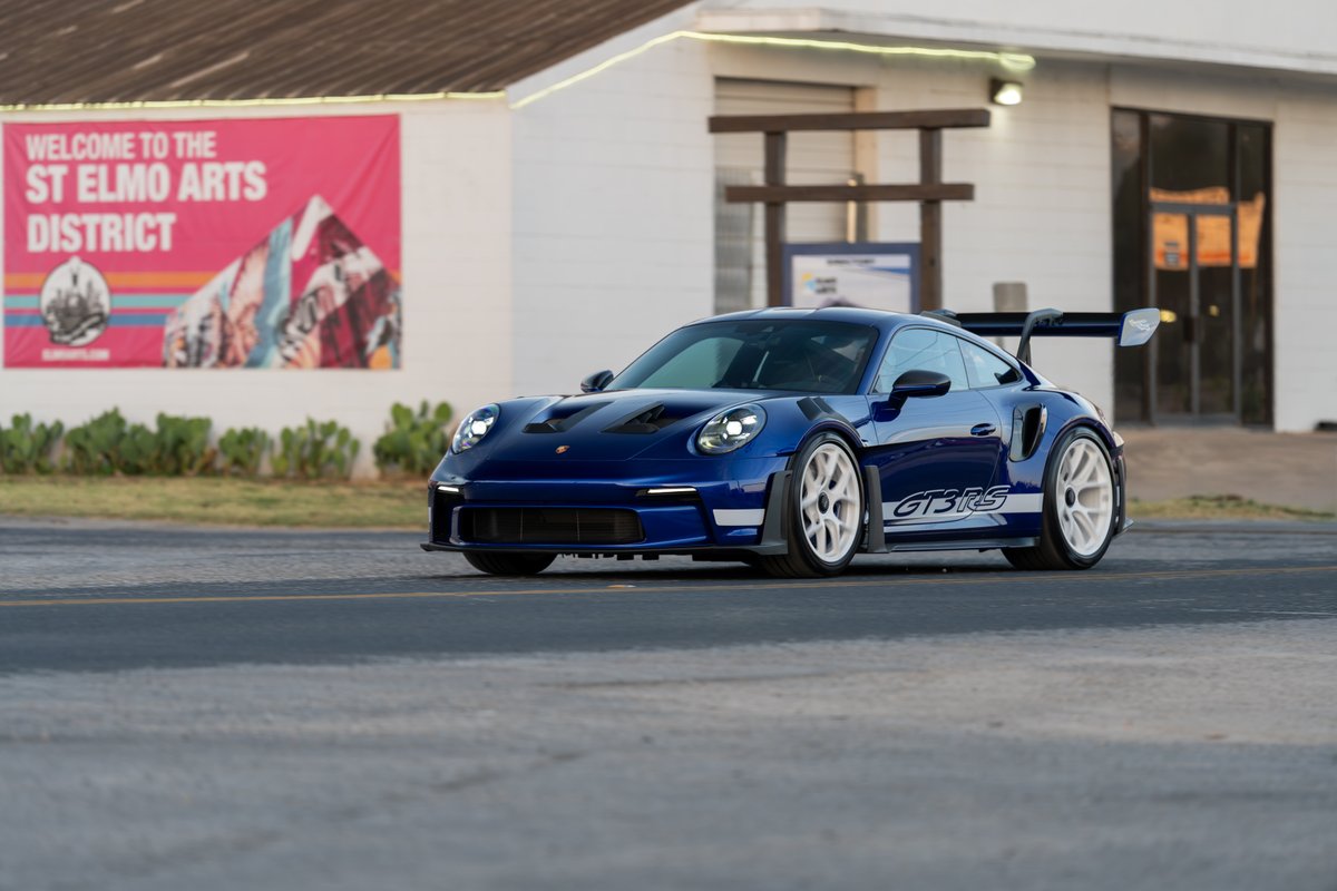 2025 Porsche 911 GT3 RS in blue with white GT3RS livery and white rims.