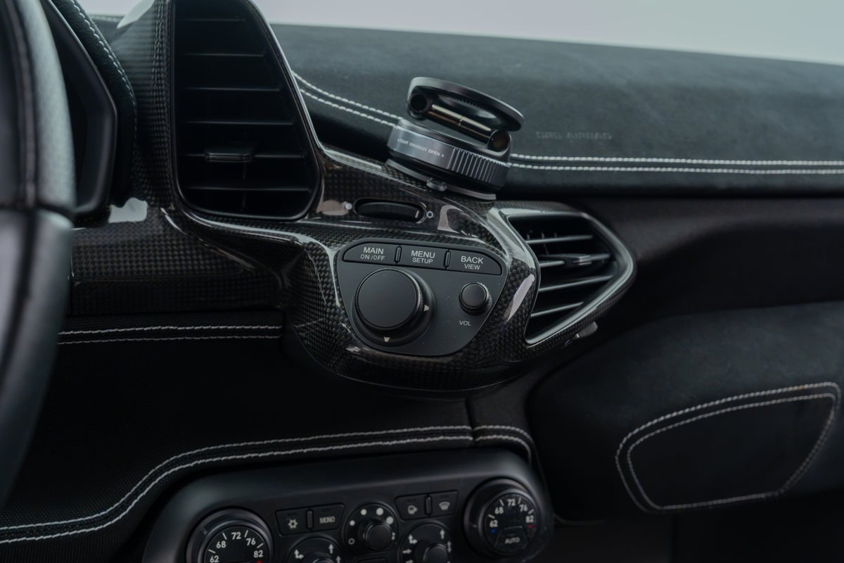 2015 Ferrari 458 Speciale carbon fiber trim with white stitching and air vents.
