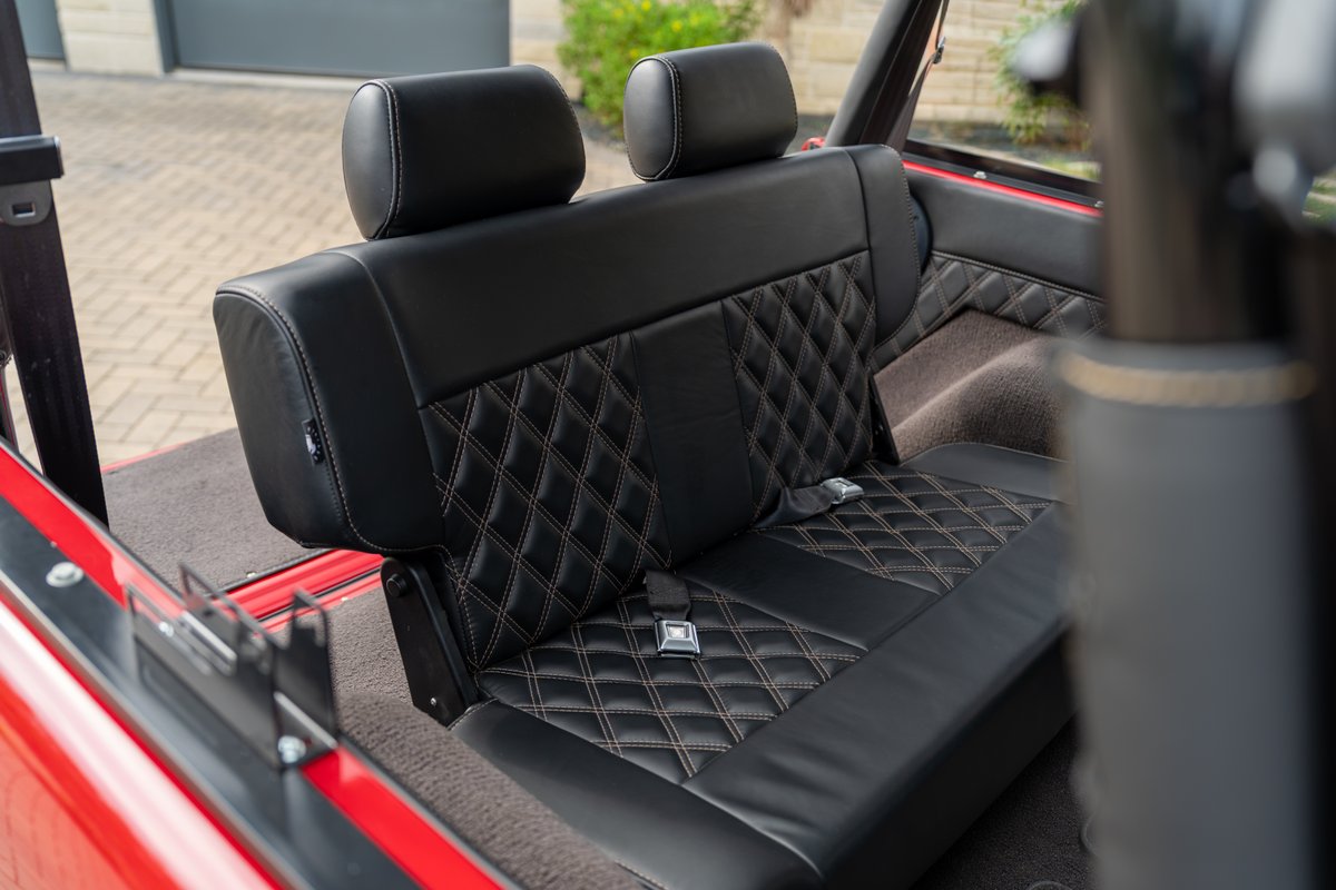 1966 Ford Bronco custom black diamond-stitched rear seats with white contrast stitching.