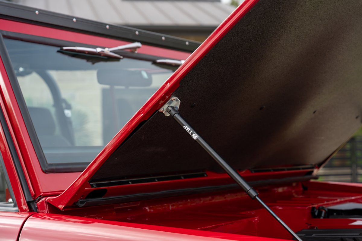 1966 Ford Bronco by Atlas Broncos in red, hood open, showing gas strut.