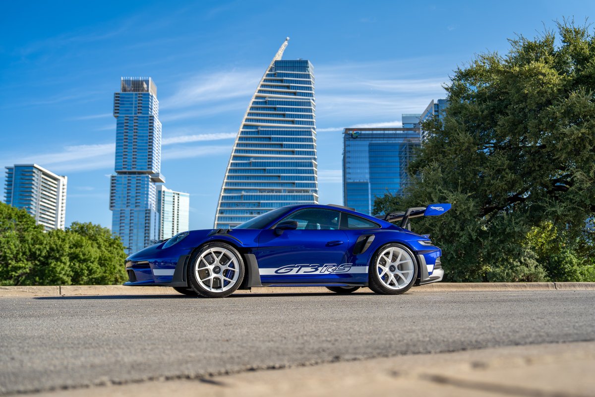 2025 Porsche 911 GT3 RS in blue with white GT3 RS livery and white rims.