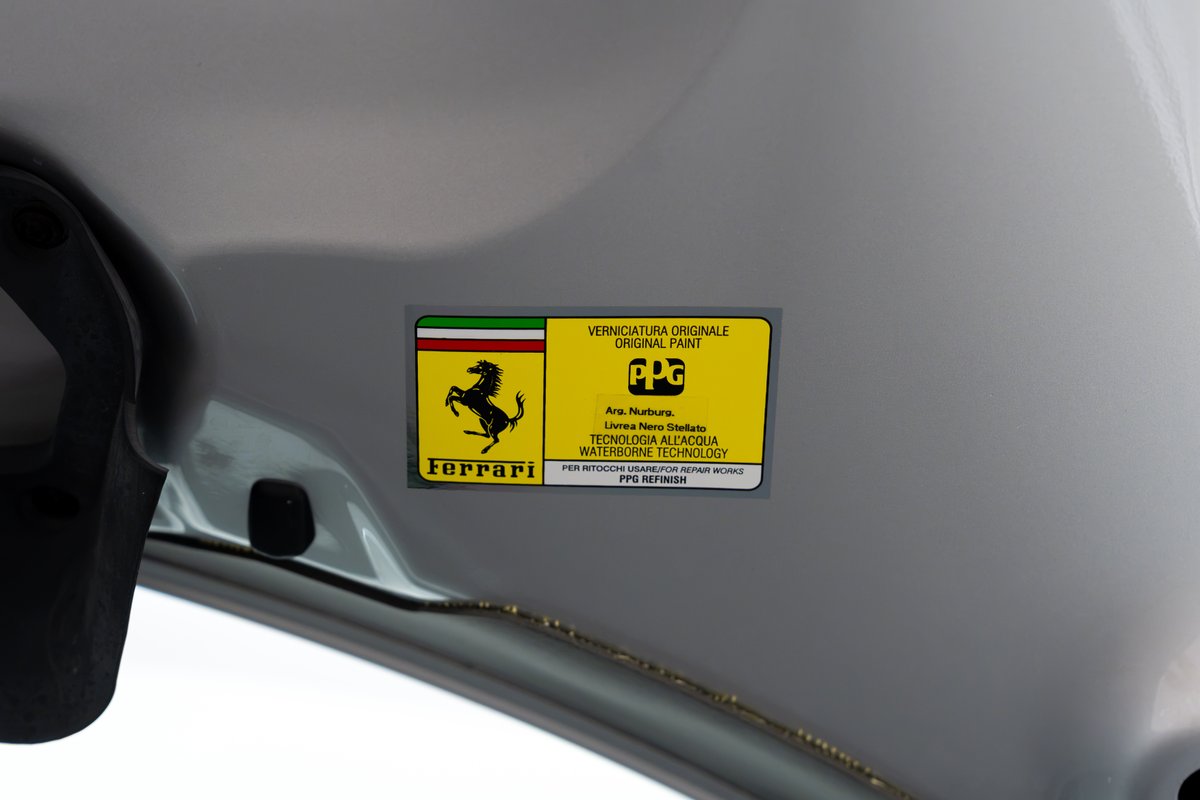 Ferrari 458 Speciale original paint sticker on silver body panel.