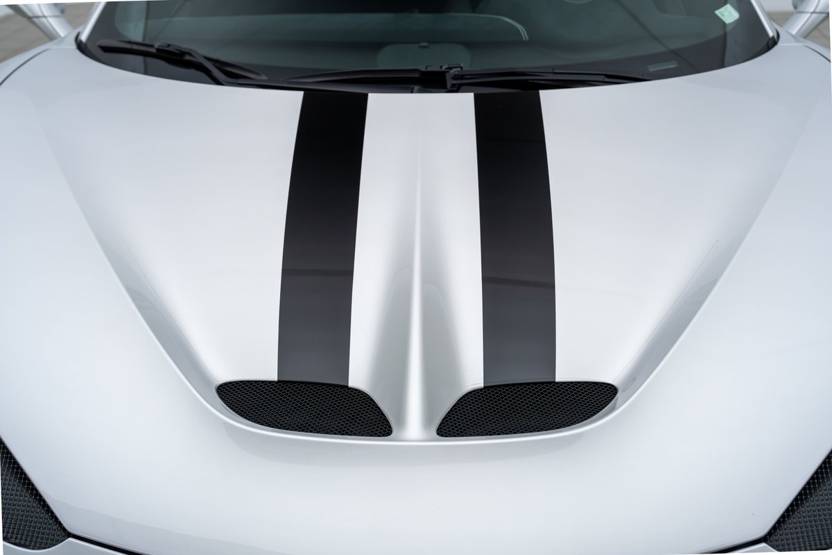 2015 Ferrari 458 Speciale hood with black racing stripes and mesh grilles.