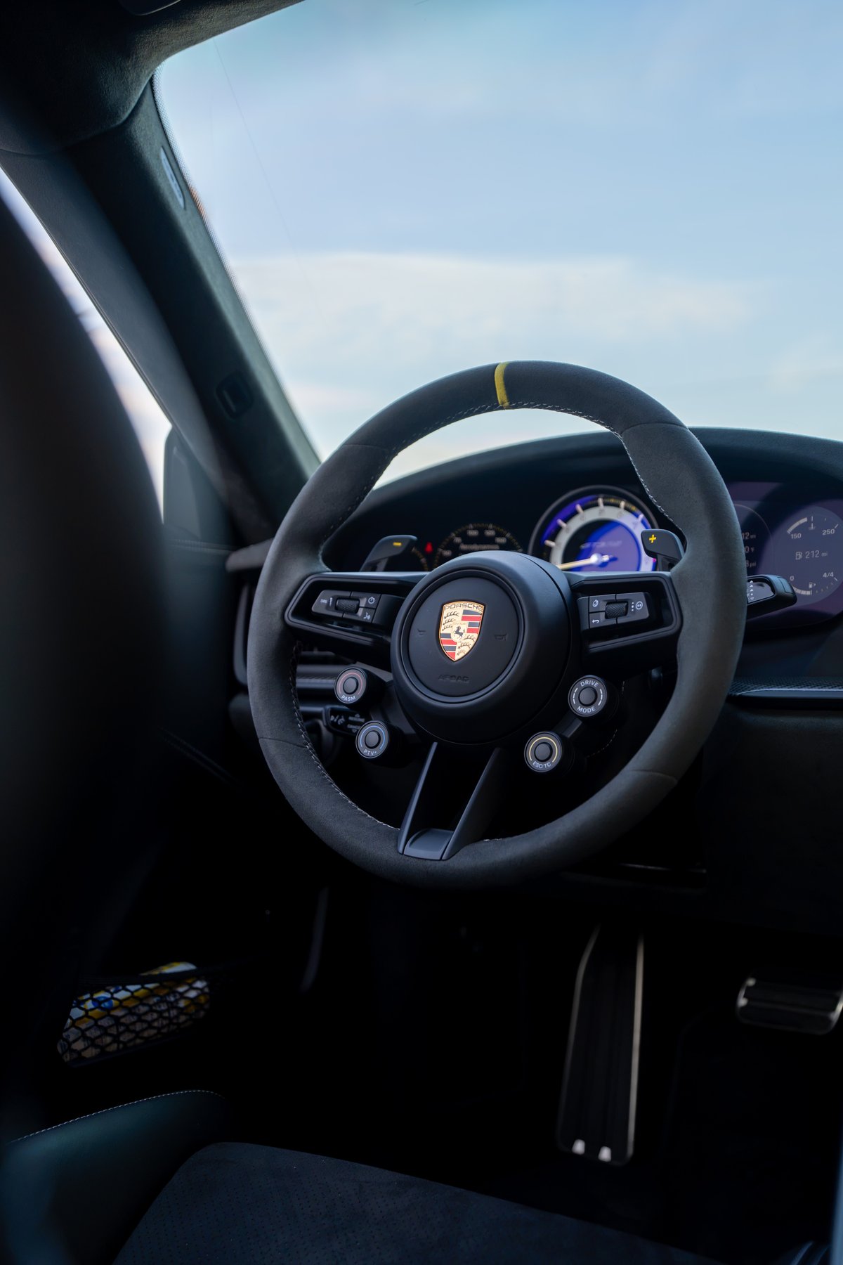 2025 Porsche 911 GT3 RS steering wheel with Alcantara trim and yellow 12 o'clock marker.