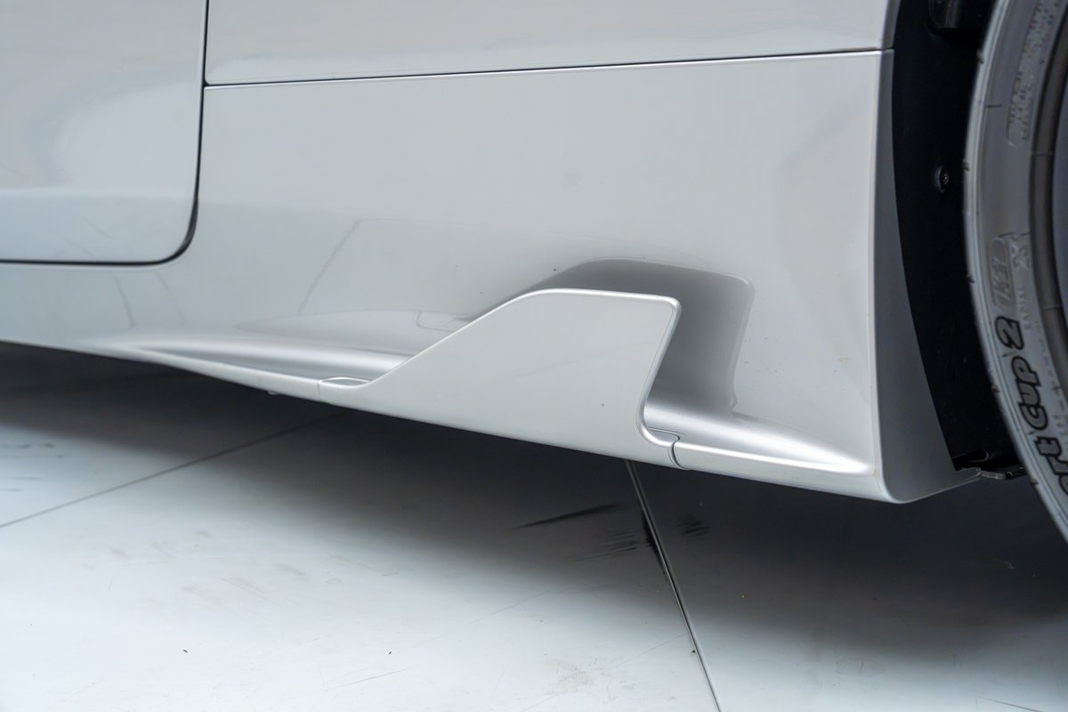 2015 Ferrari 458 Speciale side skirt with integrated aero winglet, silver.